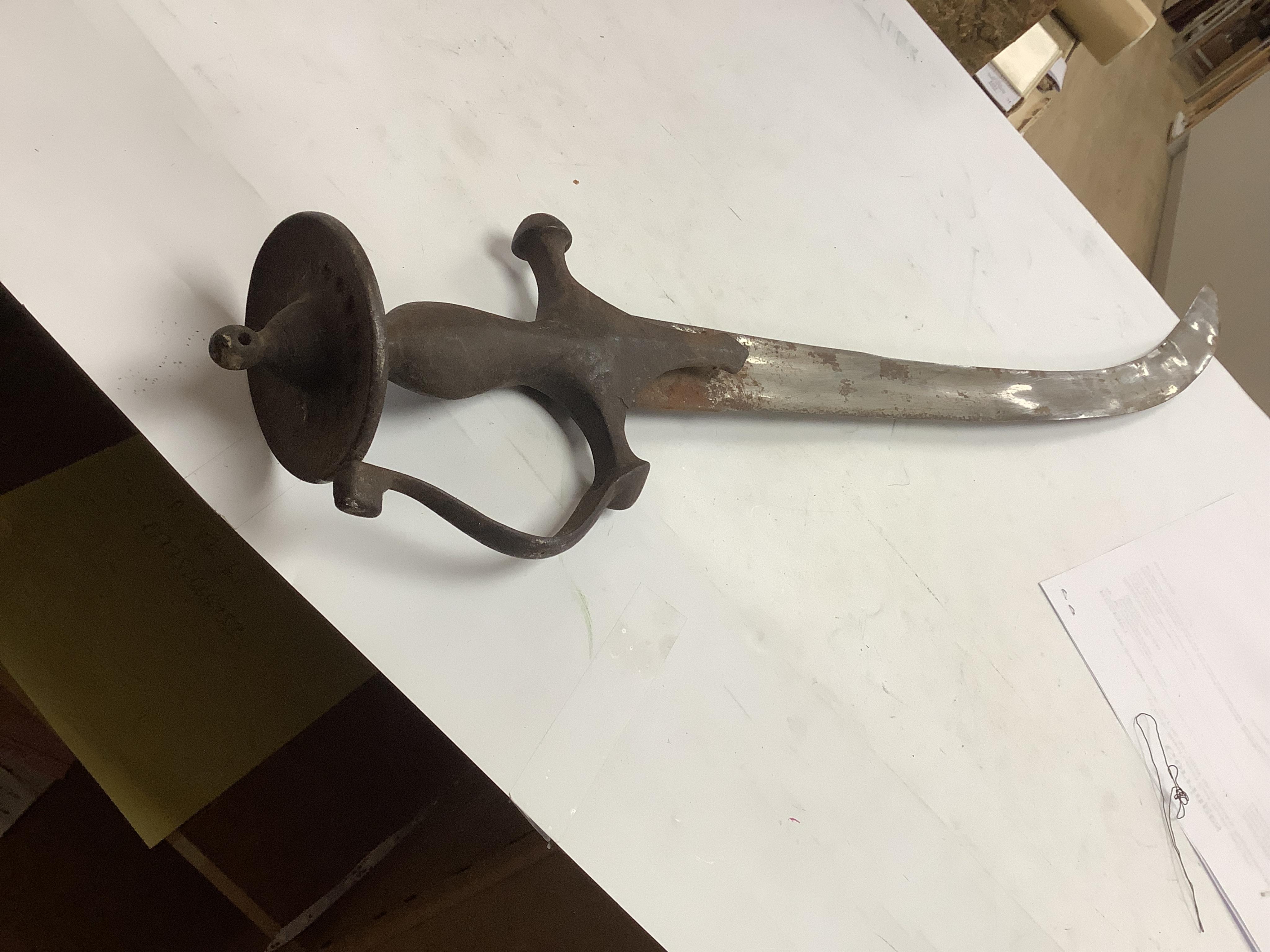 An Indian Tulwar sword, in scabbard and two small kukri, largest 93cm long.